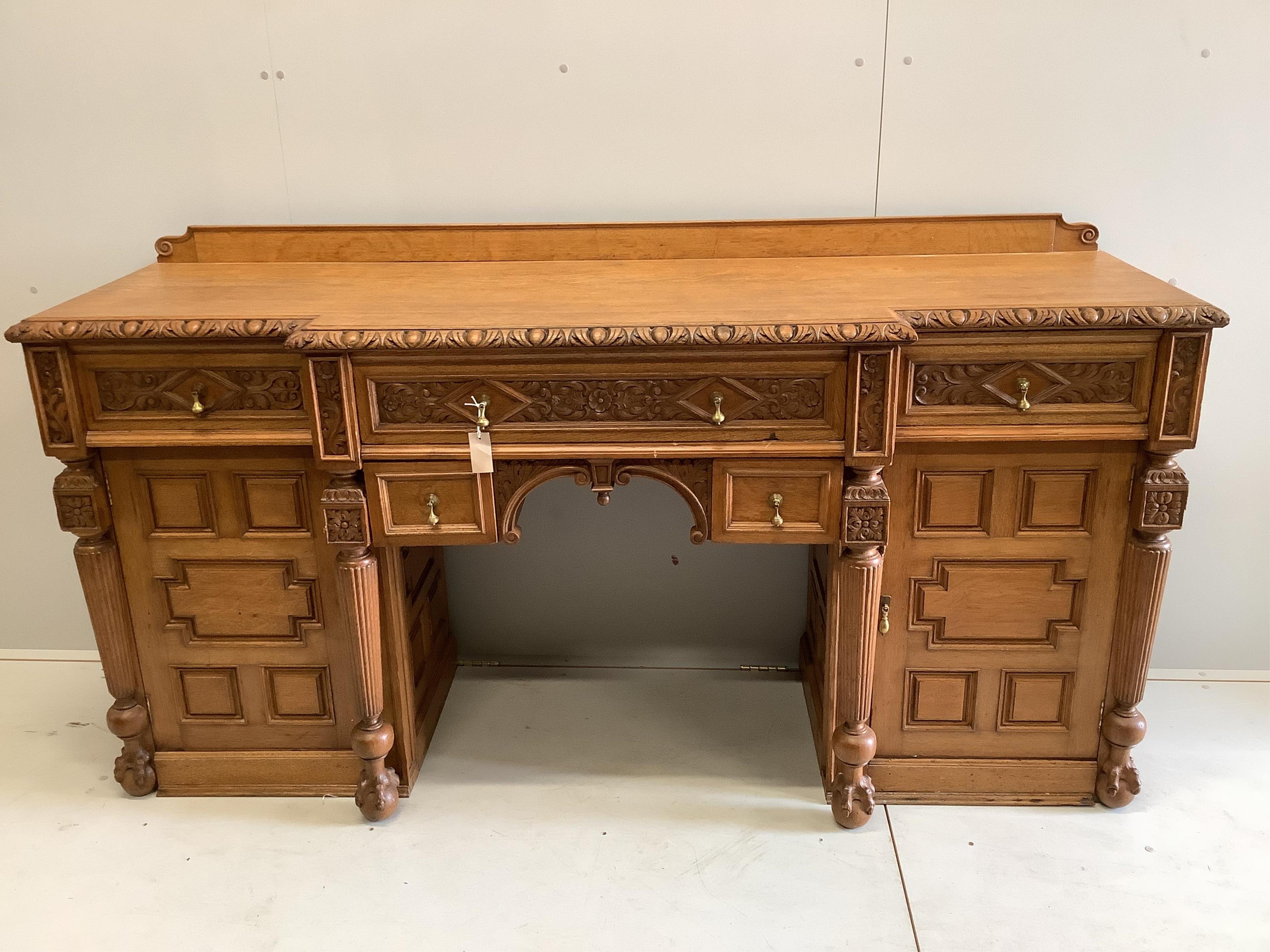 A late Victorian Jacobean Revival oak breakfront sideboard, width 200cm, depth 60cm, height 100cm. Condition - fair